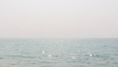 Gün boyunca güneş ışığı ve deniz dalgalarının yansıması ve açık gökyüzü