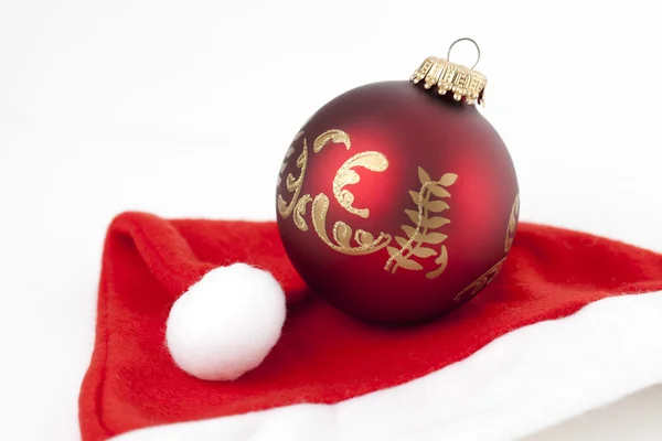 Christmas bauble on a Santa's hat — Stock Photo, Image