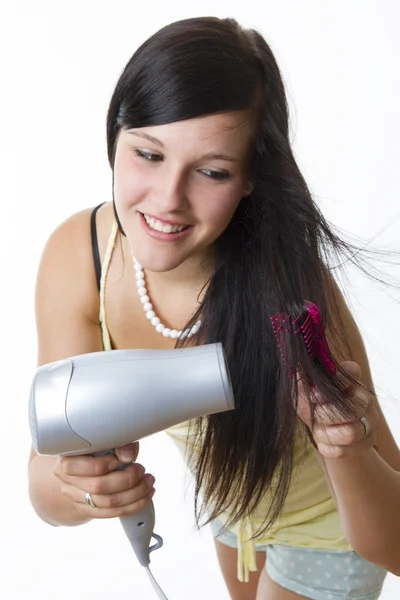 Girl with hairdryer Stock Picture