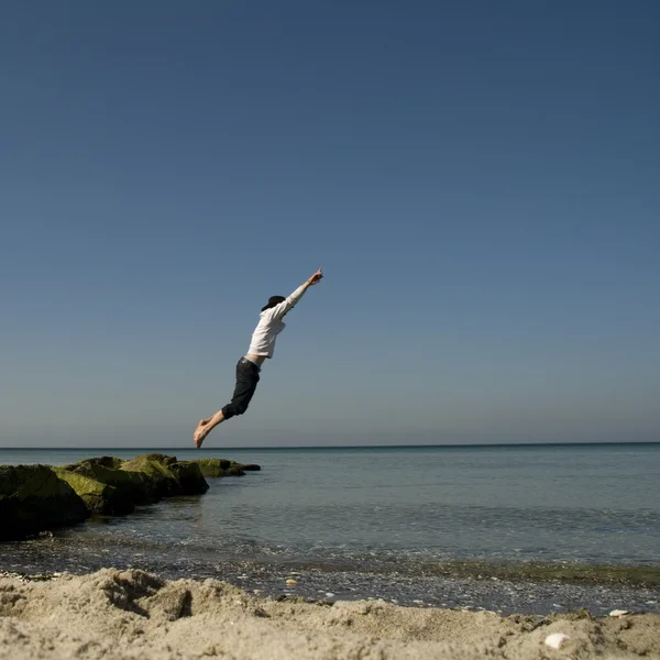 Person jumping on the beach — Stock Photo, Image