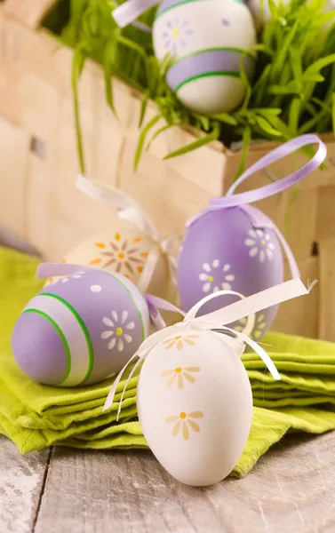 Eastern eggs with grass in the basket — Stock Photo, Image