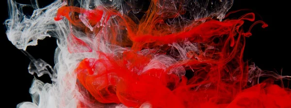 Rote und weiße Tinte im Wasser lizenzfreie Stockfotos