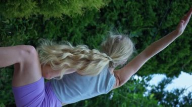 Albino girl, outdoor training, yoga class, slow motion 4k, vertical video. High quality footage