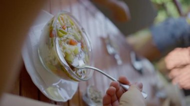 The girl eats a delicious vegetarian soup from vegetables and seeds, slow motion, close-up. High quality 4k footage