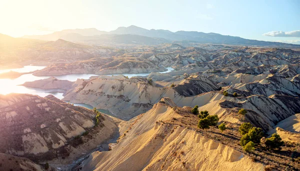 Badlands landscape of the Barrancos de Gebas in the Region of Murcia with a swamp in the center and the Sierra Espua Natural Park in the background