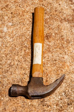 A hammer is left on the concrete pavement.