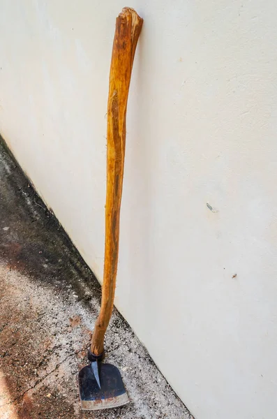 Una Azada Negra Con Largo Palo Madera Apoya Una Pared — Foto de Stock