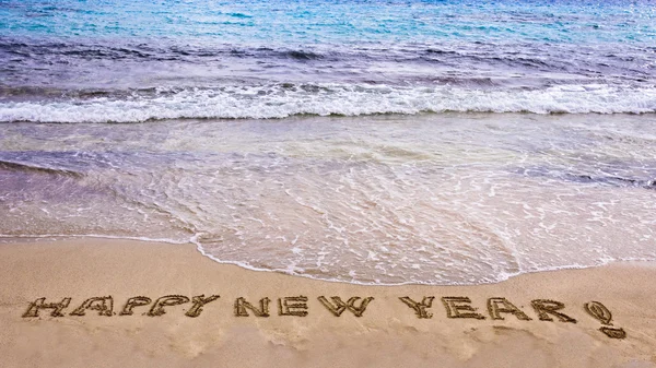 Happy new year and exclamation point written in the sand — Stock Photo, Image