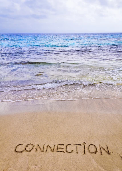 Connection word written on sand, with waves in background — Stock Photo, Image