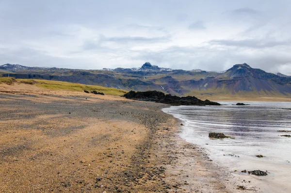 Sand beach with black voulcanic rocks in Iceland near Budir - small town on Snaefellsnes peninsula — Stock Photo, Image