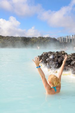 Beautiful young woman in Blue Lagoon geothermal spring , Iceland clipart