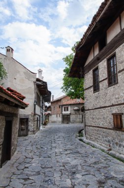 View of paved walkway with traditional bulgarian architecture from Bansko, Bulgaria clipart