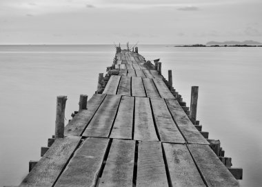 Black and white photography of a beach wooden pier clipart
