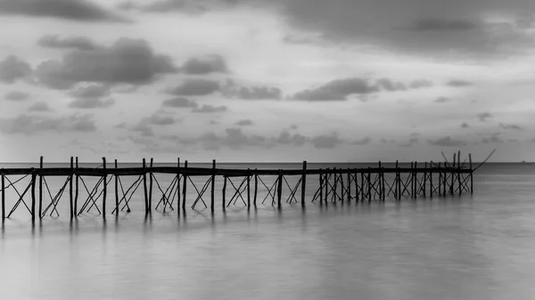 Black and white photography of a beach wooden pier Stock Image