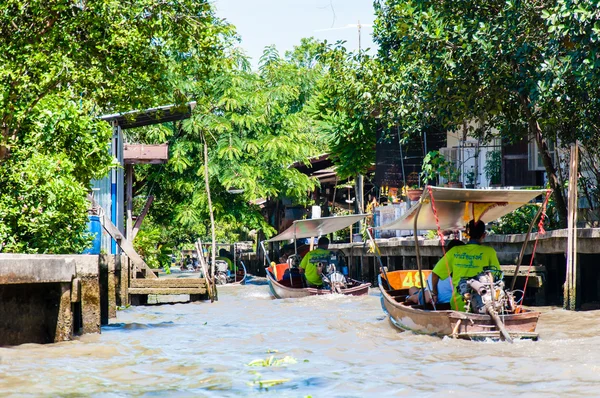 Los lugareños tailandeses venden comida y recuerdos en el famoso mercado flotante Damnoen Saduak en Tailandia, en la antigua forma tradicional de vender desde pequeños barcos. . —  Fotos de Stock