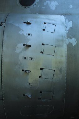 instructions on the body of a military aircraft on a faded blue background.