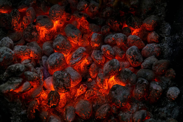 Burning embers of the fireplace top view. Close up. Burning Coal.