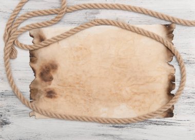 abstract background with burnt paper on wooden planks with rope