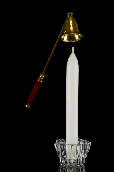 Candle in glass candlestick and candle snuffer — Stock Photo, Image