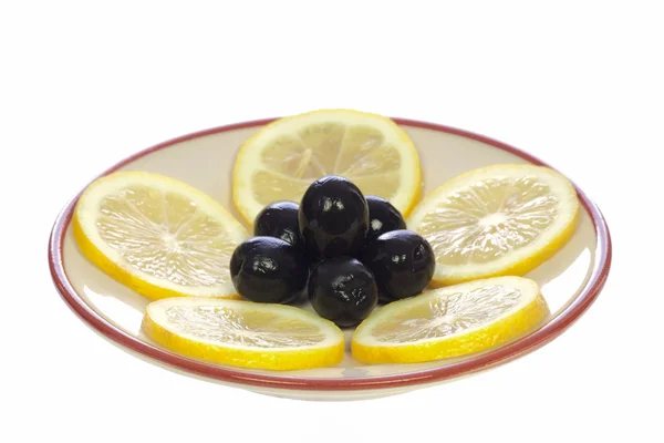 Lemons and olives on the saucer — Stock Photo, Image