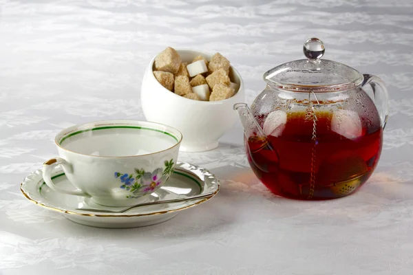 Teapot with tea, cup on a saucer and sugar bowl — Stock Photo, Image