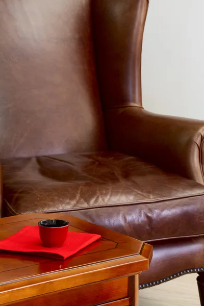 Coffee table and leather armchair — Stock Photo, Image