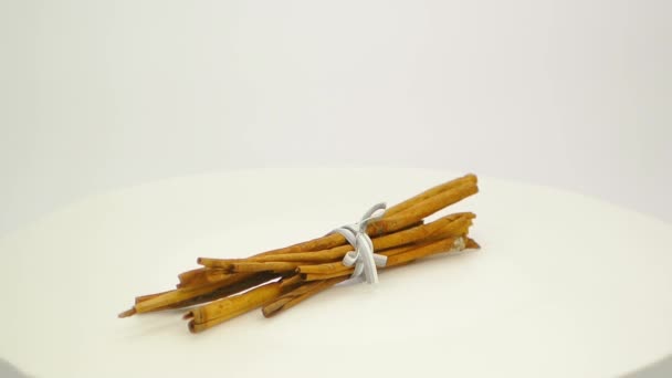 Bunch of cinnamon sticks tied with a grey ribbon FullHD 1080p — Stock Video