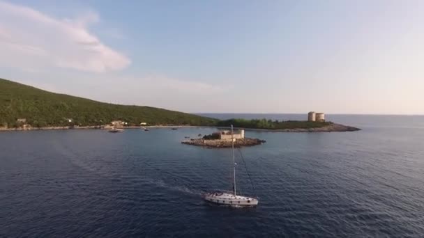 Fehér vitorlás jacht vitorlázik át Zhanic sziget és megy a nyílt tengerre — Stock videók