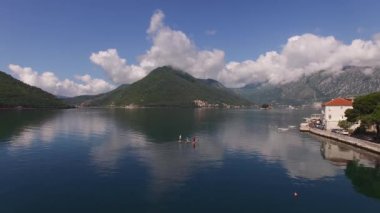 Sörfçüler Kotor Körfezi boyunca sörf tahtalarında yelken açarlar. Perast, Karadağ