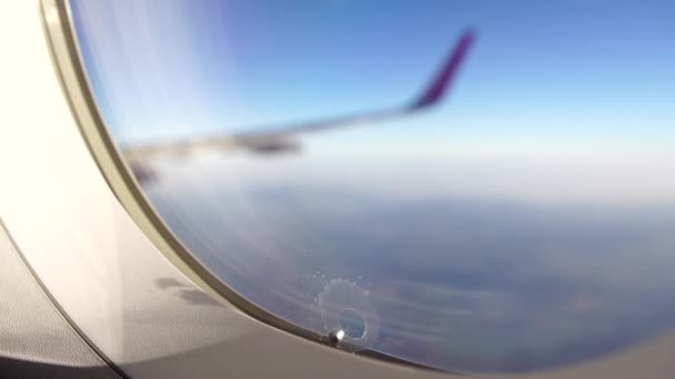 Vista desde el ojo de buey de un ala de avión durante la turbulencia — Vídeo de stock