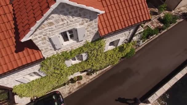 道路の桟橋の横に沿って車のドライブは、石造りの家を過ぎて。モンテネグロ — ストック動画