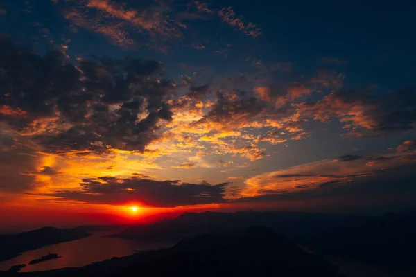 Orange clouds in the sun rays over the bay. View from Mount Lovcen — Stock Photo, Image