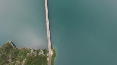 Piva Gölü üzerindeki otomobil köprüsünün üstü kayalık dağlar arasında.