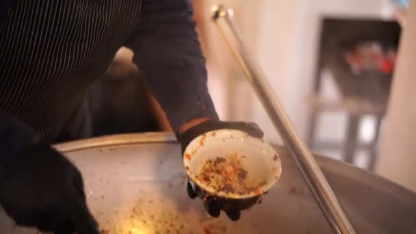 厨师用开槽的勺子从大锅中倒入一个深盘 — 图库视频影像