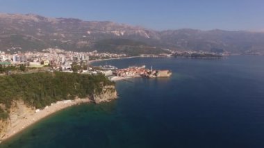 Kotor Körfezi 'ndeki Budva kasabasının insansız hava aracı görüntüsü yeşil dağların arka planına karşı