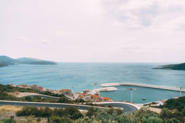 Dağlardan, Lustica körfezine, rıhtıma ve binalara bakın. Karadağ
