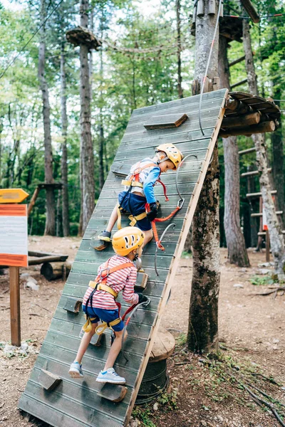 Jungen klettern Kletterwand im Abenteuerpark — Stockfoto