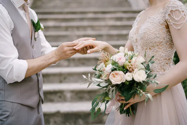 Groom coloca o anel na noiva enquanto está de pé nos degraus — Fotografia de Stock