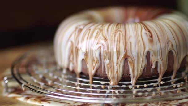 Шоколадный торт с глазурью стоит на столе — стоковое видео