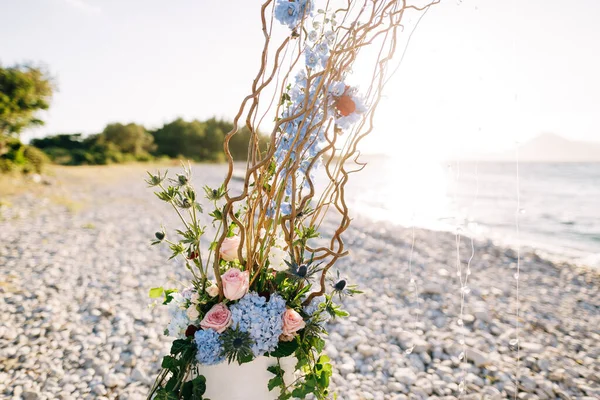 Fragment of a flower arrangement of a wedding semi-arch on a pebble beach by the sea — Fotografia de Stock