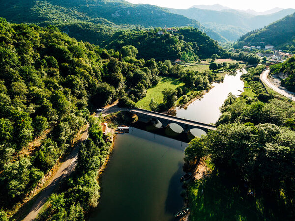 Aerial view of the Crnojevica river surrounded by green trees. Montenegro