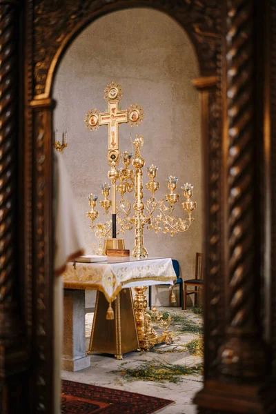 Branched gold candlestick on a table in front of a cross in the Church of St. Sava in Tivat. Montenegro — ストック写真