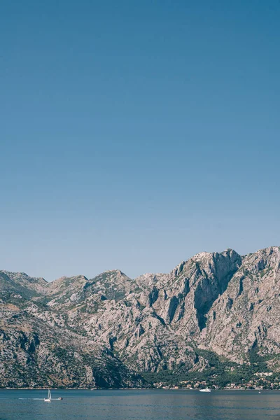 Enorme catena montuosa sulla riva della baia di Kotor sullo sfondo del cielo blu — Foto Stock