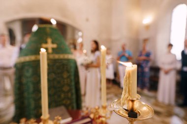 Candles burn during a wedding ceremony in a church