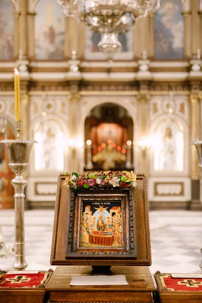 Ícone em um estande fica na mesa em frente ao altar na Igreja de St. Sava em Tivat — Fotografia de Stock