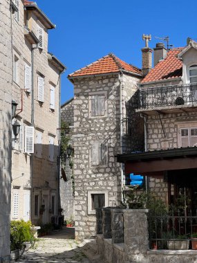 Yard with old stone houses with red tiled roofs. High quality photo