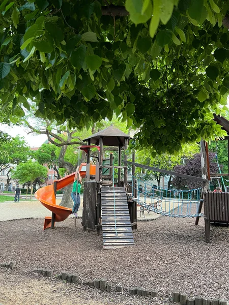 Spiral Slide Playground Foliage Tree High Quality Photo — Stock fotografie