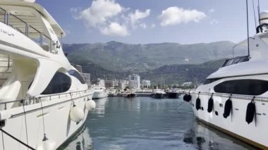 White yachts at the pier against the backdrop of mountains. High quality 4k footage