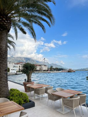 Open air restaurant by the sea under palm trees. High quality photo