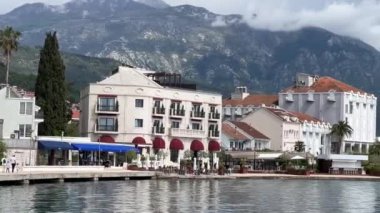 Embankment with old buildings against the backdrop of mountains. Montenegro. High quality FullHD footage